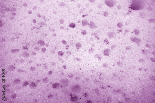 Cleaning sponge surface close up in purple color.