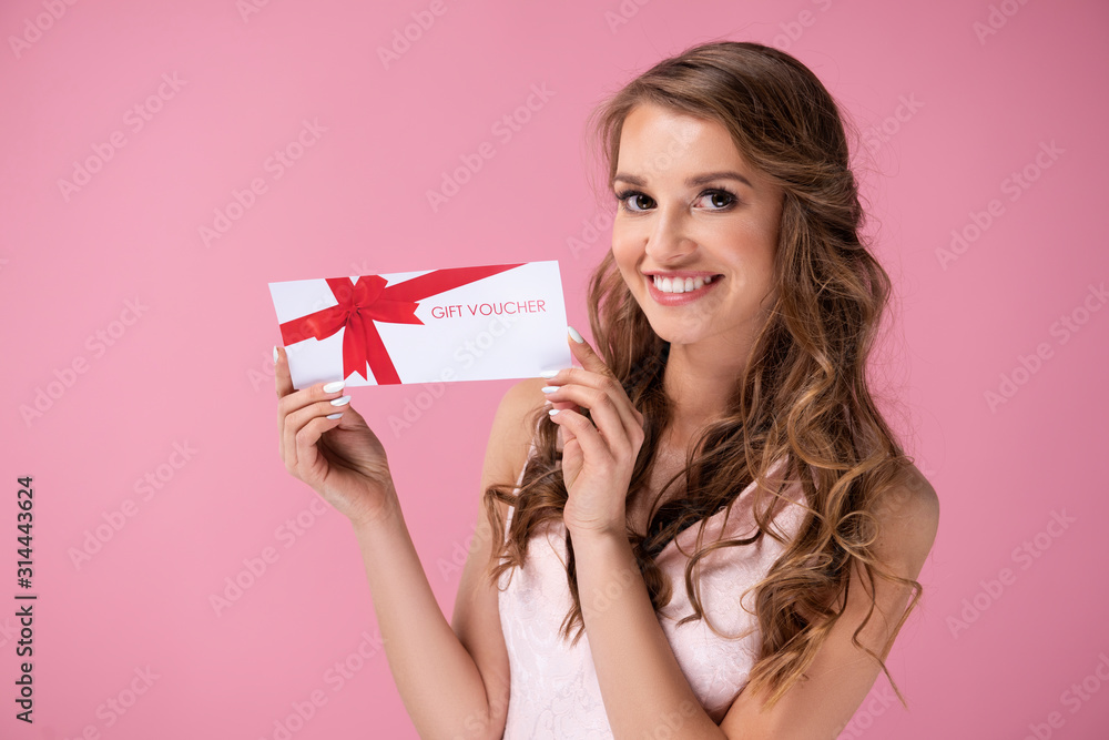 Portrait of beautiful woman giving a gift voucher Portrait of beautiful woman giving a gift voucher