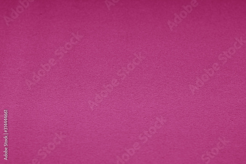 Plastic glittering texture with blur effect in pink tone.