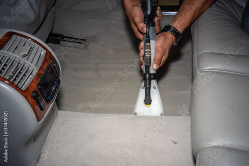 Cleaning of interior of the car with vacuum cleaner