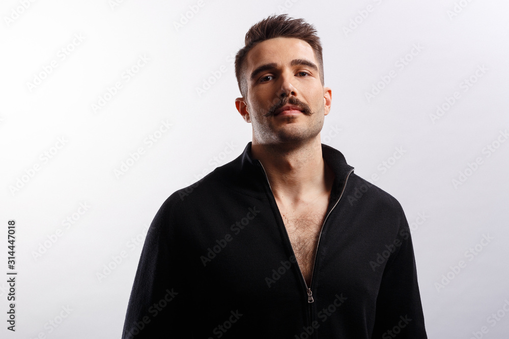 Portrait of a handsome bearded man wear in black jacket, looking at camera over white background. Portrait of a handsome bearded man wear in black jacket, looking at camera over white background.
