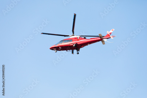 Small private helicopter on a background of blue sky