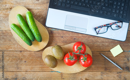 Принти на полотні Healthy food on working table with laptop, vegetables and fruit, healthy lunchbr