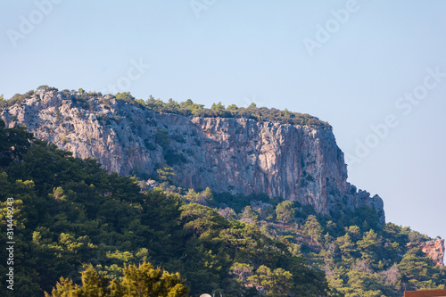 Mountain landscape with a protruding rock on a background of greenery