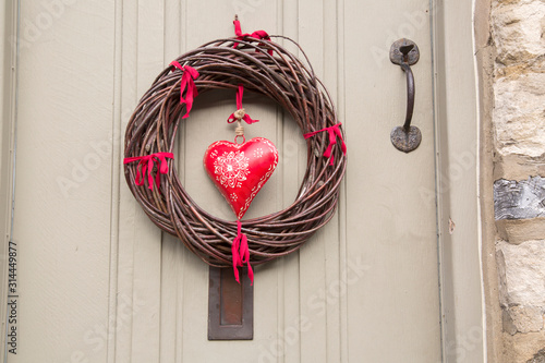 Red Heart Christmas Wreath on Wooden Front Door