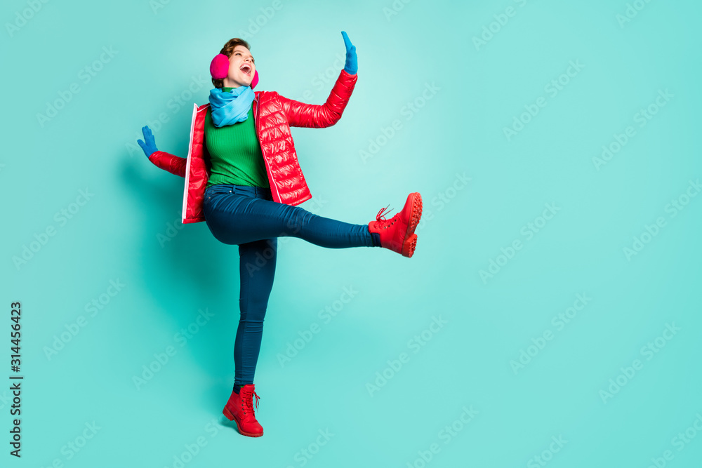 Weekend. Full length photo of funny lady walk street dance raise leg good  mood wear casual red coat scarf pink ear muffs pants jumper gloves shoes  isolated teal color background Stock Photo |