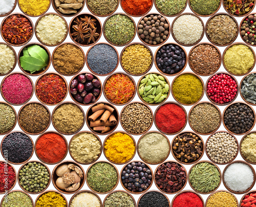 Fototapeta Naklejka Na Ścianę i Meble -  various condiments isolated on white background. spices and herbs in cups
