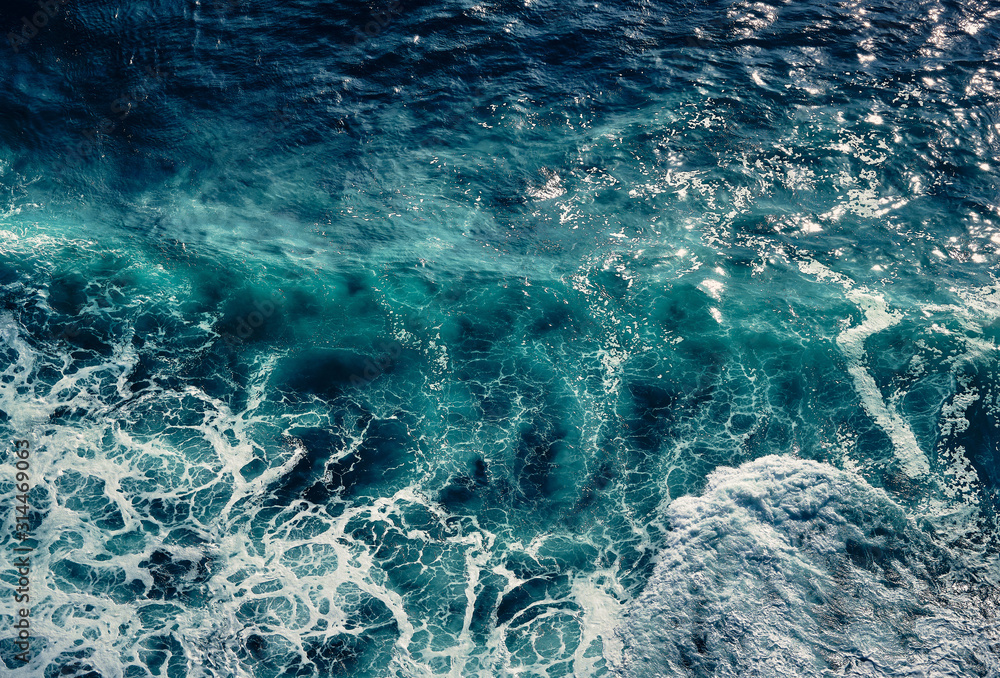 Aerial view to waves in ocean Splashing Waves. Blue clean wavy sea water. Seething waves with foam.