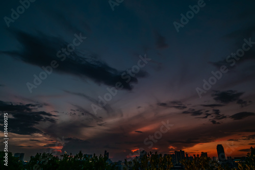 Natural Sunset in evening downtown silhouette at bangkok. .Bright Dramatic Sky And Dark Ground. city Landscape Under Scenic Colorful Sky At Sunset. Sun Over Skyline, Horizon. Light blue background.