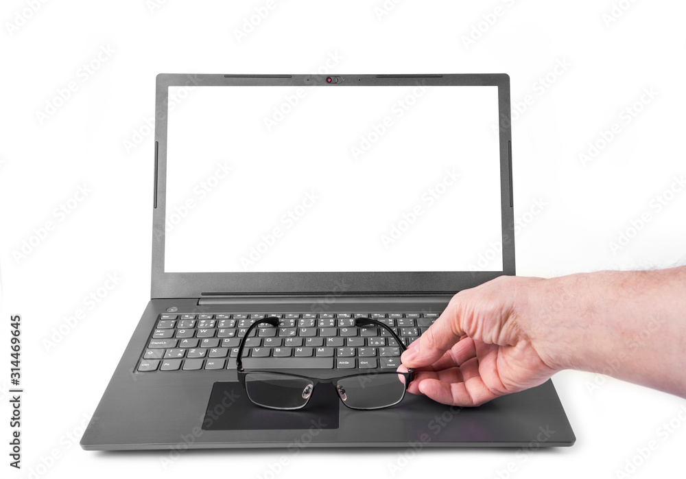 Modern slim laptop with a hand and pair of glasses Modern slim laptop with a hand and pair of glasses