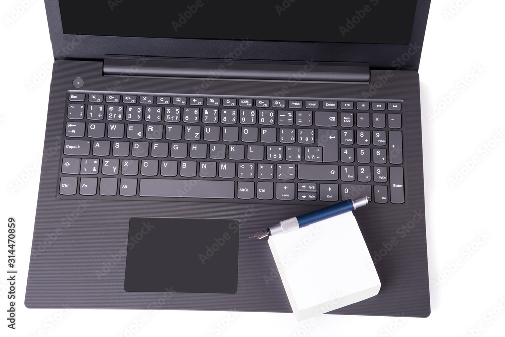 Modern slim laptop with pile of note paper and pair of glasses Modern slim laptop with pile of note paper and pair of glasses