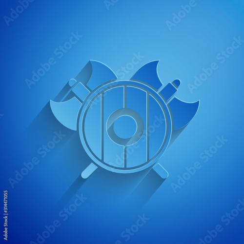 Paper cut Medieval shield with crossed axes icon isolated on blue background. Battle axe, executioner axe. Paper art style. Vector Illustration