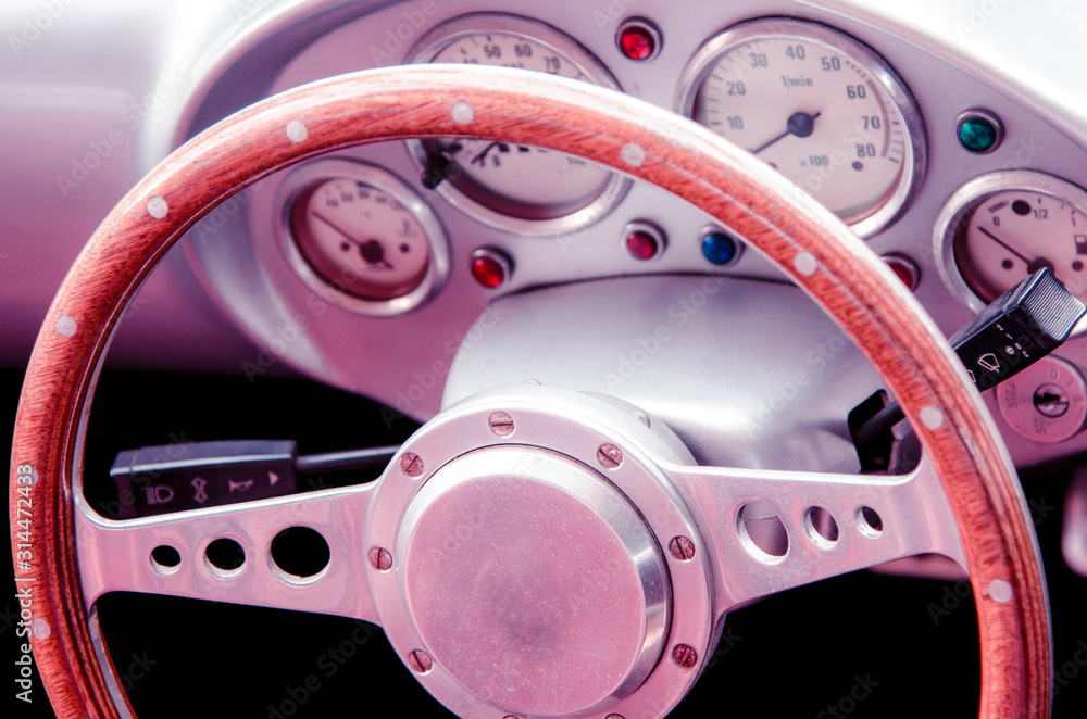 Fragment of interior retro car with speedometer and steering. vintage style