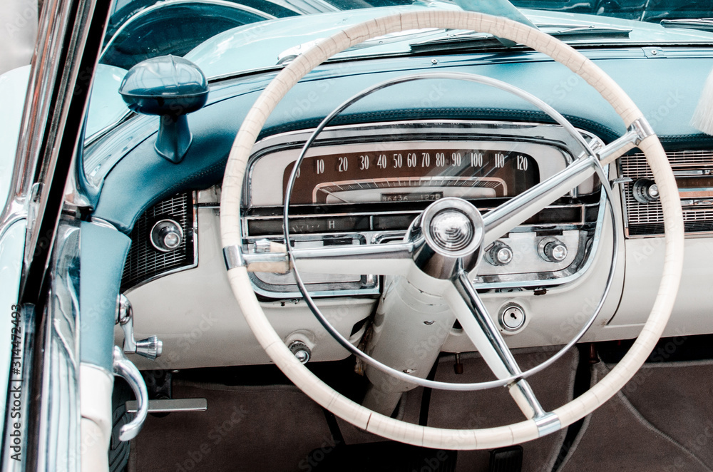 Fragment of interior retro car with speedometer, toggle switches and steering. vintage style
