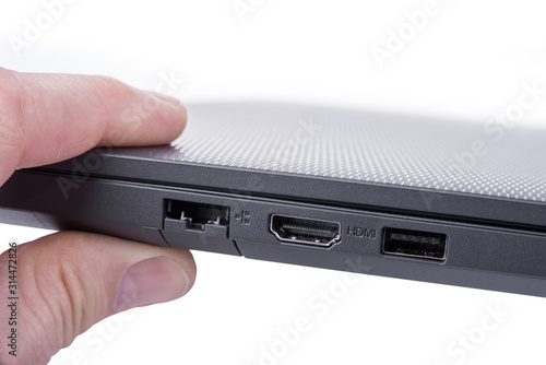 Wallpaper Mural Modern slim lightweight laptop  hold with two fingers Torontodigital.ca