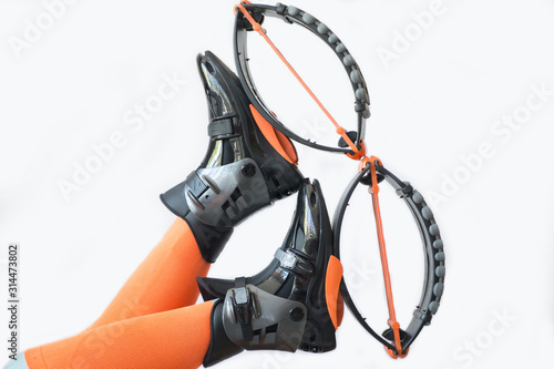 Kengo boots for sports. Kengo boots are shod on feet in orange leggings. Kengo boots isolated on a white background photo