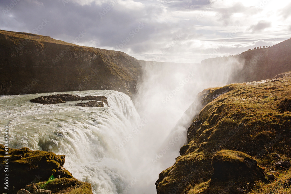 Landscape with big majestic Gullfoss waterfall in mountains in Iceland Landscape with big majestic Gullfoss waterfall in mountains in Iceland