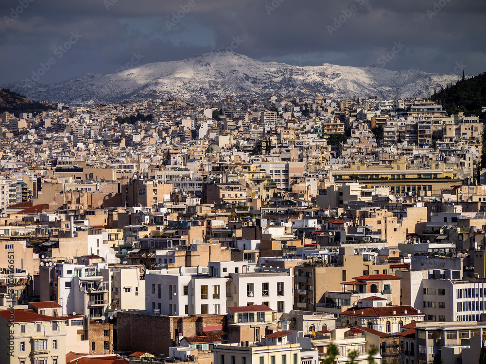 Beautiful view of sunny Athens with snowy mountain tops.