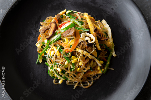 Stir fried Korean glass noodle with soy sauce called Japchae