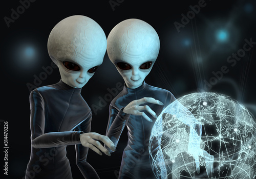 Vászonkép Two aliens study the planet Earth on a light map