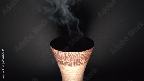 Burning incense against a white background, emirate and Saudi traditions bakhoor, ramadan Kareem concept photo