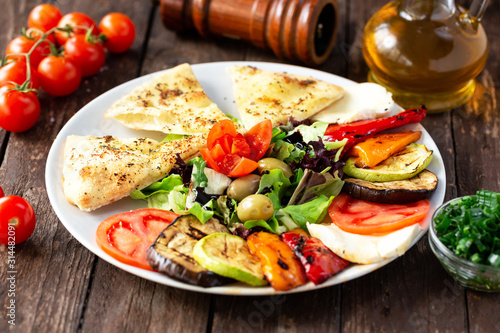 Grilled and fresh vegetables together on one plate
