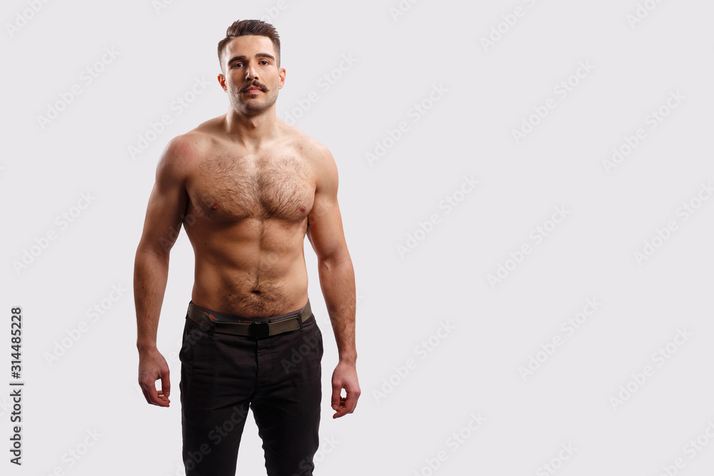 Portrait of a handsome bearded man with naked torso, looking at camera over white background. Horizontal view with copy space. Portrait of a handsome bearded man with naked torso, looking at camera over white background. Horizontal view with copy space.