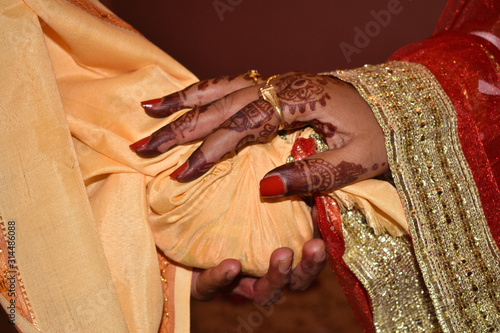 Close up of Asian couple's hands at a wedding, concept of marriage, partnership, commitment