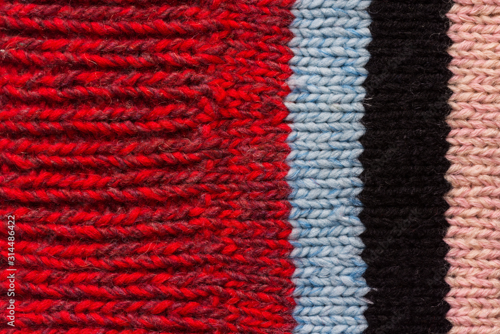 Stockinette stitch knitted fabric pattern from organic woolen yarn with stripes. Fashion clothing crafts knitting hobby concept Stockinette stitch knitted fabric pattern from organic woolen yarn with stripes. Fashion clothing crafts knitting hobby concept