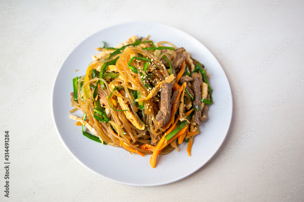 Stir fried Korean glass noodle with soy sauce called Japchae Stir fried Korean glass noodle with soy sauce called Japchae