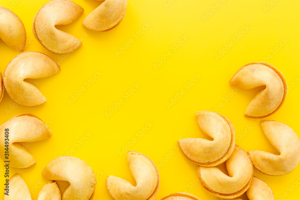 Fortune cookie frame on yellow background top-down copy space Fortune cookie frame on yellow background top-down copy space