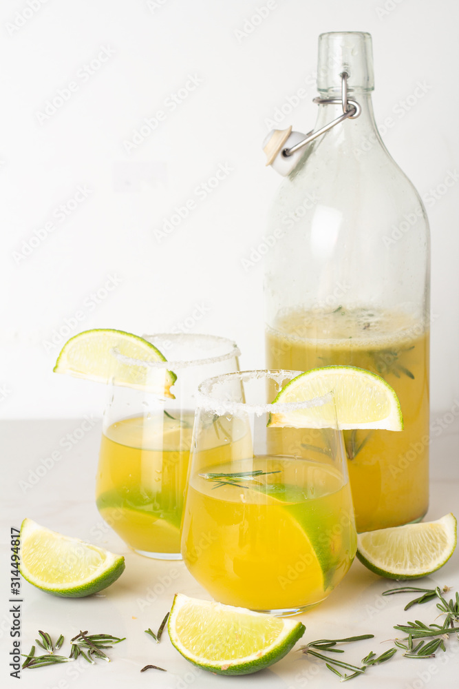 lime drink in a glass with salt and citruses and a bottle with a drink lime drink in a glass with salt and citruses and a bottle with a drink