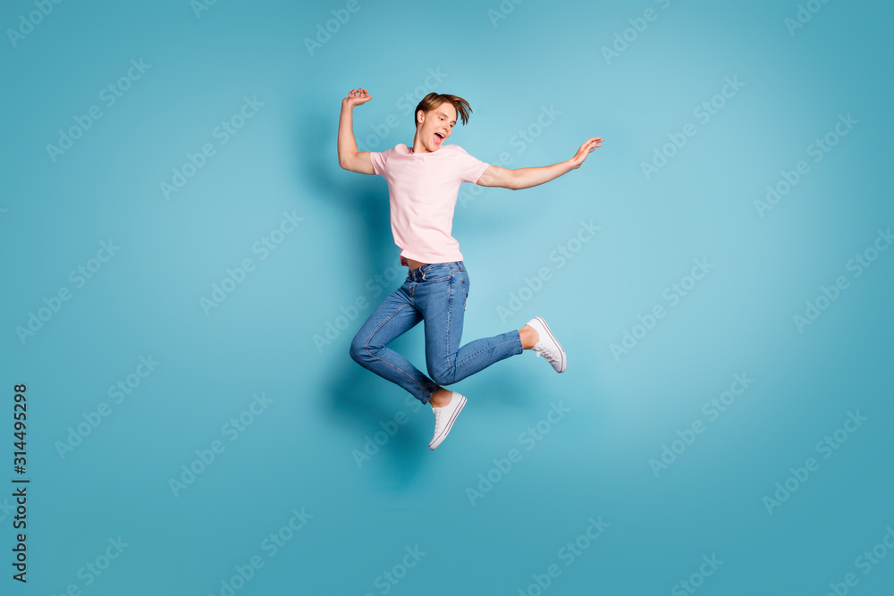 Portrait of funny enthusiastic guy enjoy spring vacation feel crazy emotion scream jump wear good-looking outfit sneakers isolated over blue color background