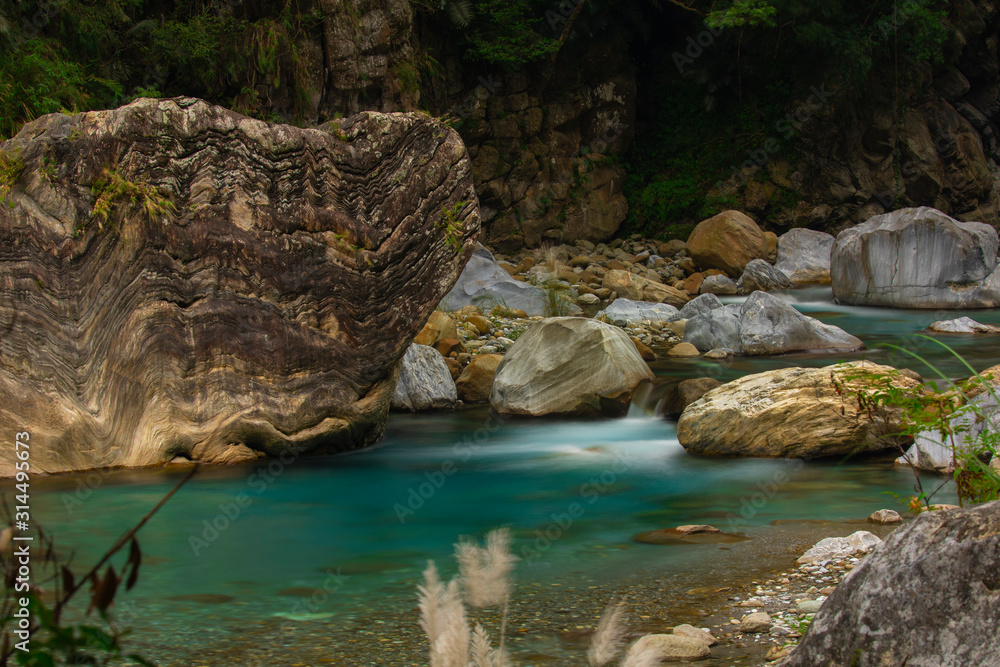 Naklejka premium Huge granite on the sand stream of the Taroko Pavilion, Hualien, Taiwan