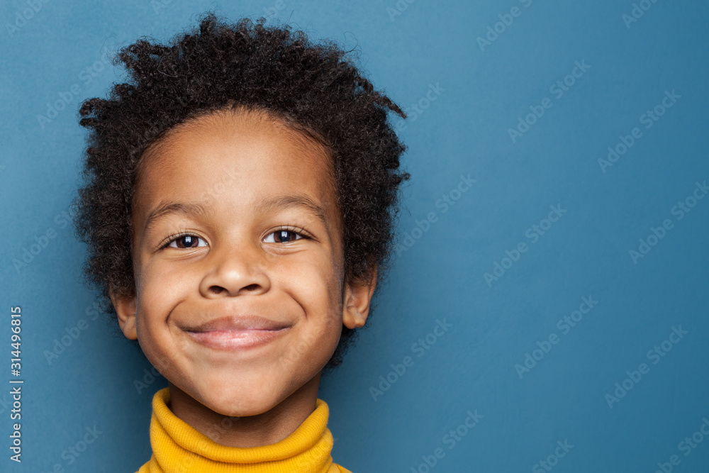 Smiling kid boy portrait. Little african american child boy on blue background - obrazy, fototapety, plakaty 