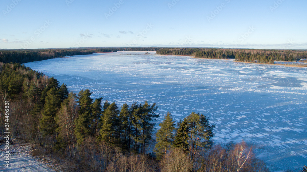 Aerial view over frozen lake with ice and snow wall formations,  Southern Estonia, Võru county, Lake Hino