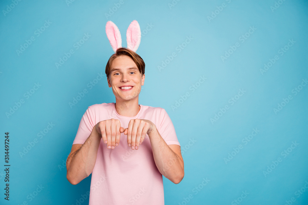 Photo of nice young guy funny good mood playing childish games bunny ears headband on head easter students party wear casual pink t-shirt isolated blue color background