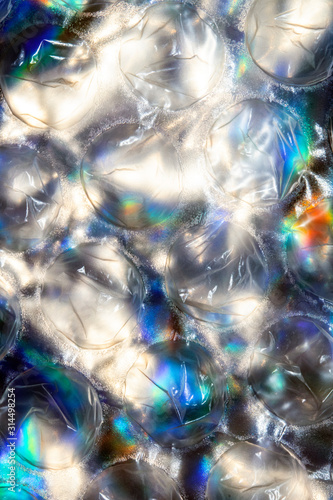 Close Up of Round Bubble Wrap on Top of Shiny Paper to Make an Abstract Background