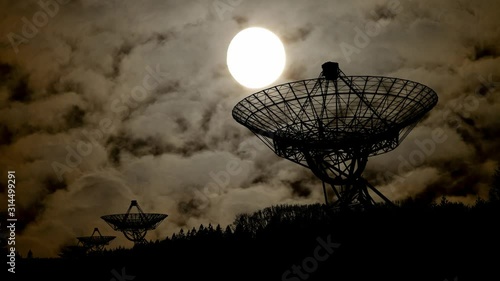 The Radio Telescope At Westerbork, (WSRT), Time Lapse by Night with Full Moon and Antennas in Silhouette, Netherlands. photo