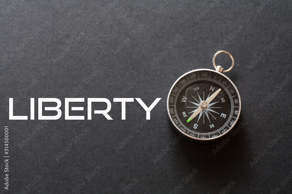 Liberty word written on black background with compass Liberty word written on black background with compass