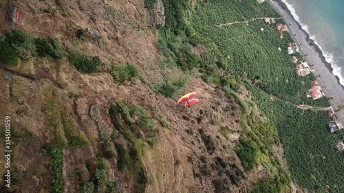 Drone aerial view of two paragliders flying over clouds and in Madeira island, Portugal photo