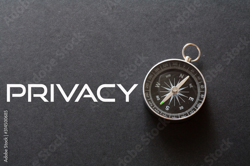 Privacy word written on black background with compass © Lemau Studio