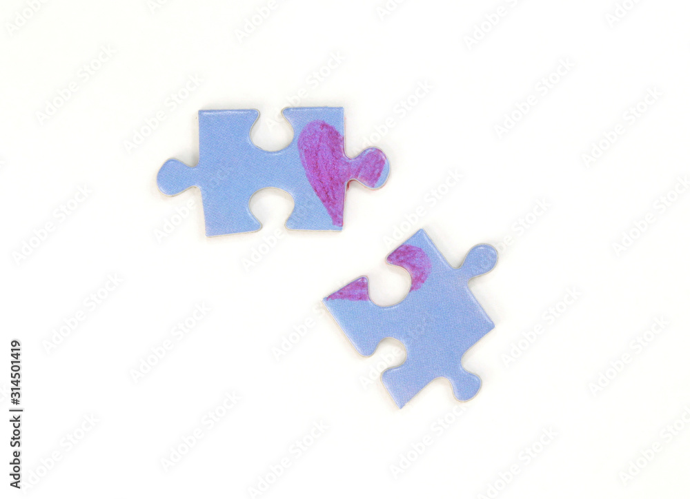 Blue puzzle with a red heart on the white isolation background. Two disconnected puzzle halves. Valentine's day stock photo with empty space for text.For web, print, postcard, background and wallpaper Blue puzzle with a red heart on the white isolation background. Two disconnected puzzle halves. Valentine's day stock photo with empty space for text.For web, print, postcard, background and wallpaper