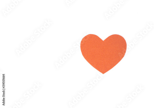 Оne felt orange heart on a white isolated background. Stock photo for the day of St. Valentine with empty space for your text. For web, print, postcards and wallpaper.