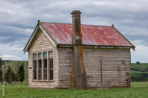 Abandoned wooden schoolbuilding. Blackmount Road. Invercargill. New Zealand. South Island. Coast photo