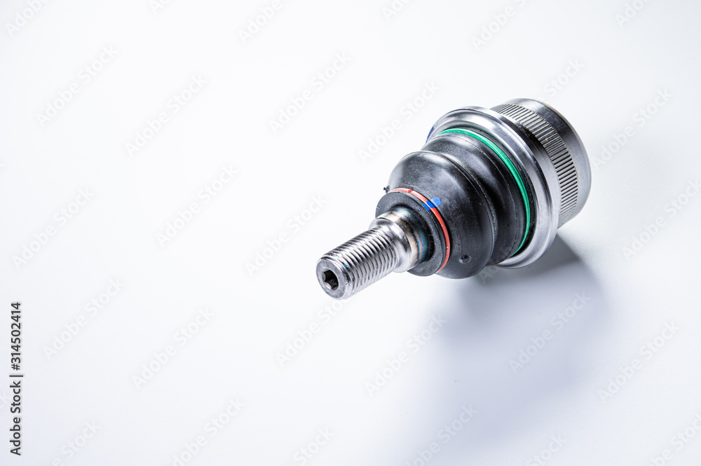 New spare parts spherical ball joints of a suspension bracket of a car on a gray background New spare parts spherical ball joints of a suspension bracket of a car on a gray background