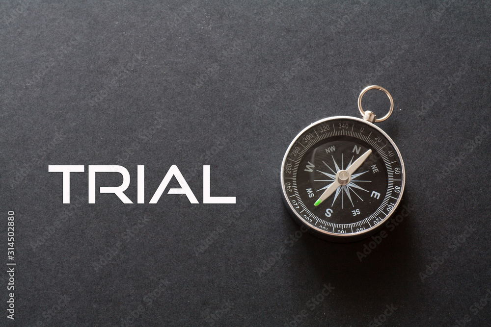 Trial word written on black background with compass