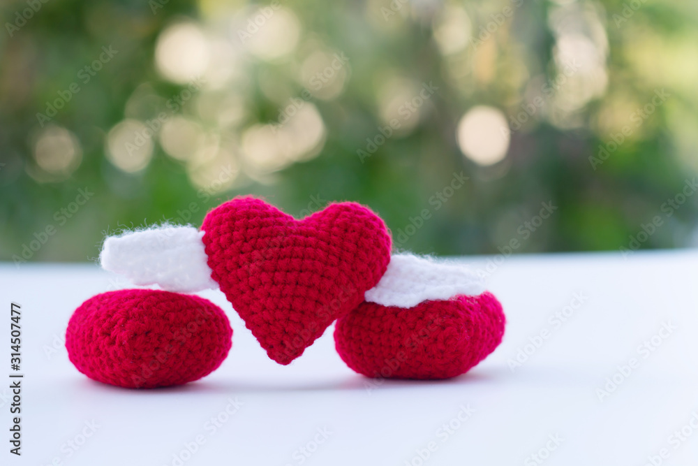 Obraz premium Beautiful red heart on a natural bokeh background. Valentine's Day .
