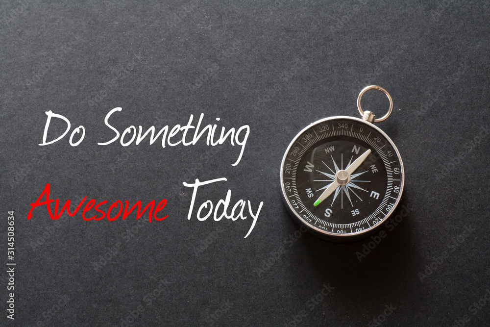 Inspirational quote : Do something awesome today ,on black background with compass Inspirational quote : Do something awesome today ,on black background with compass