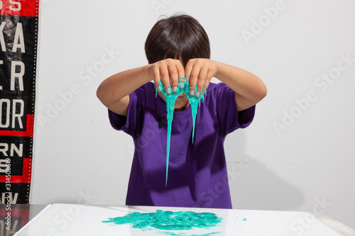 Kid playing with edible slime from edible experiments project. photo